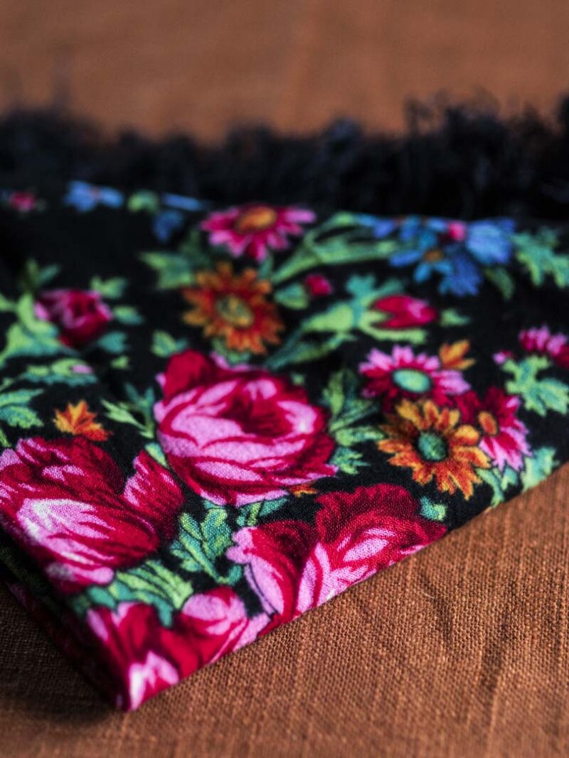 Black scarf with floral pattern.