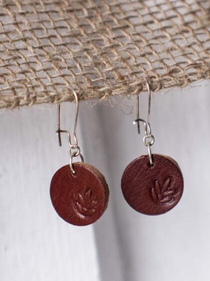 Leather earrings with punched leaves.