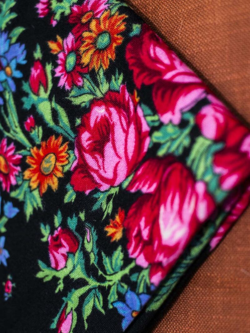 Black scarf with floral pattern.