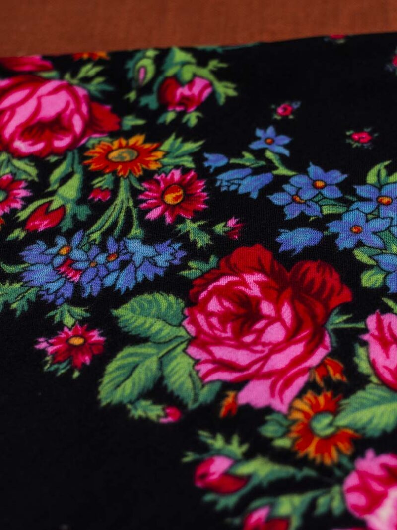 Black scarf with floral pattern.